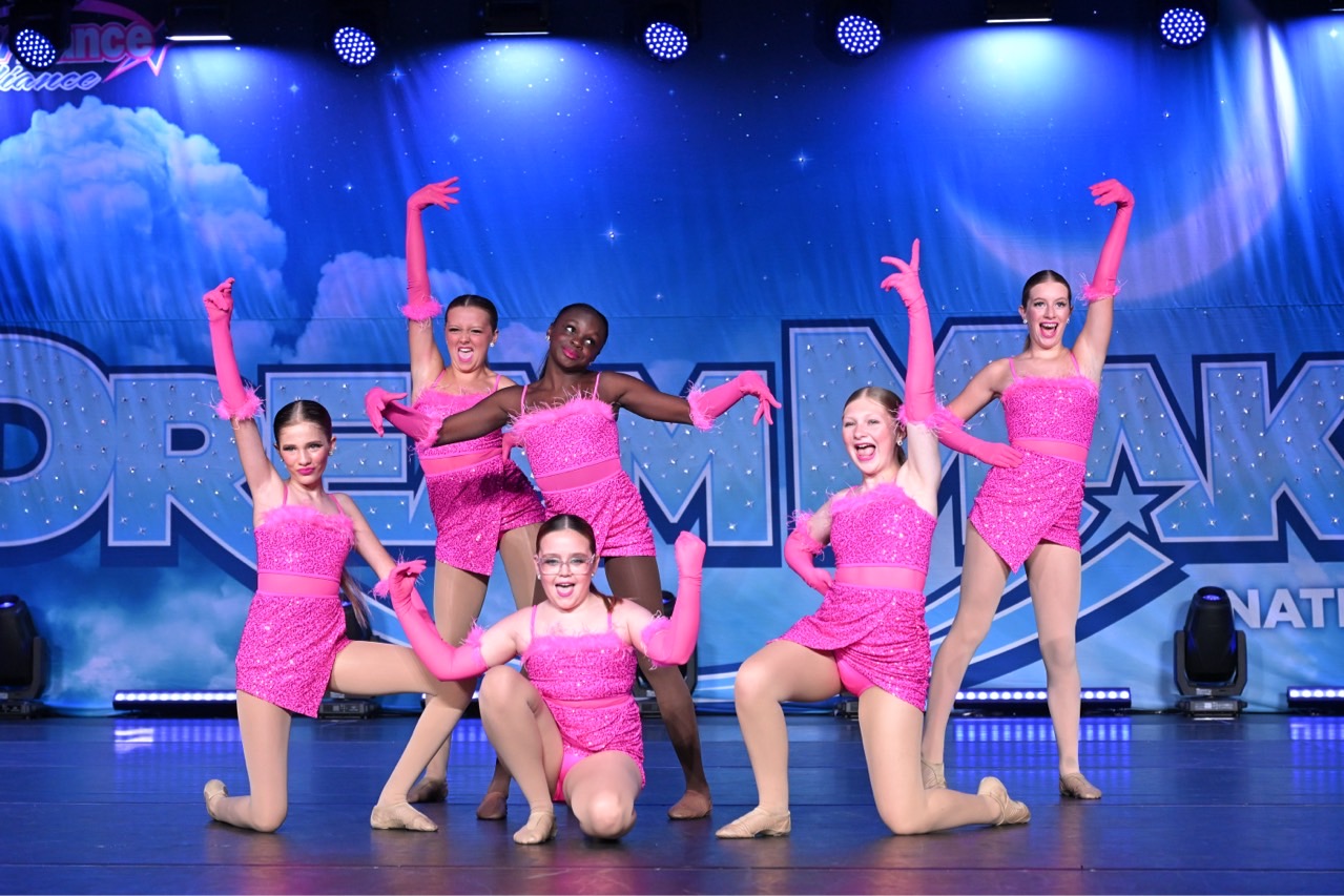 IMPACT dancers performing a pink group number at nationals